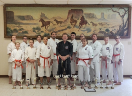 Victory Martial Arts Monticello brought home a host of awards and accolades from the United States Karate Alliance World Championships and finished ninth in the nation in their first competitive season. Members of the team include: (top row, left to right) Jaylynn Mooneyhan, Taylynn Christensen, Tina Christensen, Ben Christensen, Cael Christensen, Michelle Trevizo, Vic Mooneyhan, Dillon DeMille, Daniel DeMille.  Bottom: Grace Bushore, Skyler Mooneyhan, Carol Van Steeter, Sensei Mark Colgan, and Jill Pearson