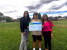 Greydon Holliday receives a big check from Zions Bank Branch Manager Kim Palmer (left) and Assistant Manager Rochelle Dandy.