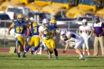 San Juan receiver Javin Montella (#22) carries the ball upfield against Bayfield defenders on August 25 with some blocking help from Jared Burke (#67) and Jake Ivins (#3). The Broncos dominated the Wolverines for a 61-0 win.  Richard Kaer photo