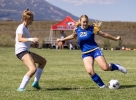 San Juan senior midfielder Macee Palmer moves the ball against a Grand County defender in the season opener in Blanding August 27.  Richard Kaer photo